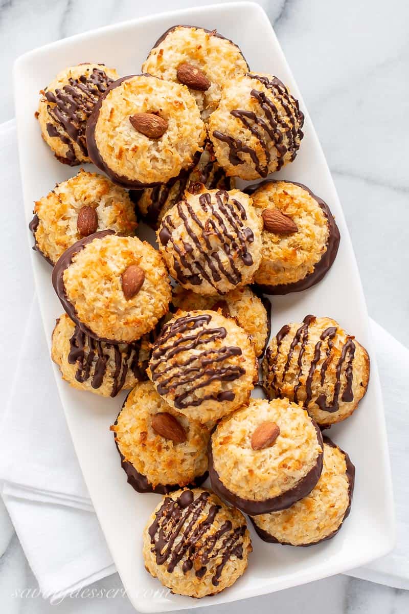 Overhead view of a platter of coconut macaroon cookies drizzled with chocolate