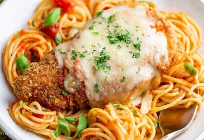 Crispy cheese topped chicken parmesan over spaghetti