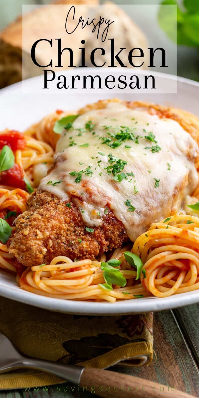 Crispy Chicken Parmesan topped with melted cheese served over spaghetti