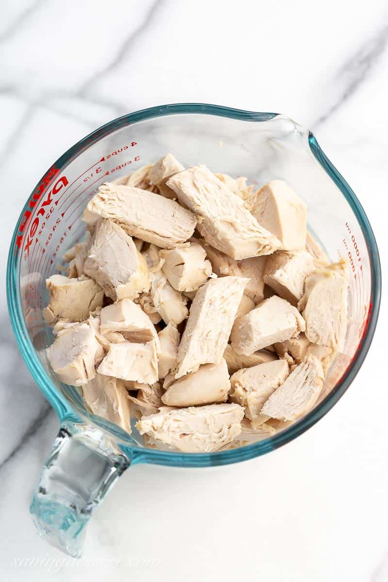 a measuring cup filled with sliced chicken breast pieces