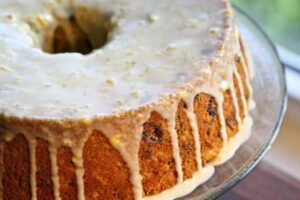 Cranberry Orange Coffee Cake with an orange glaze spooned over the top