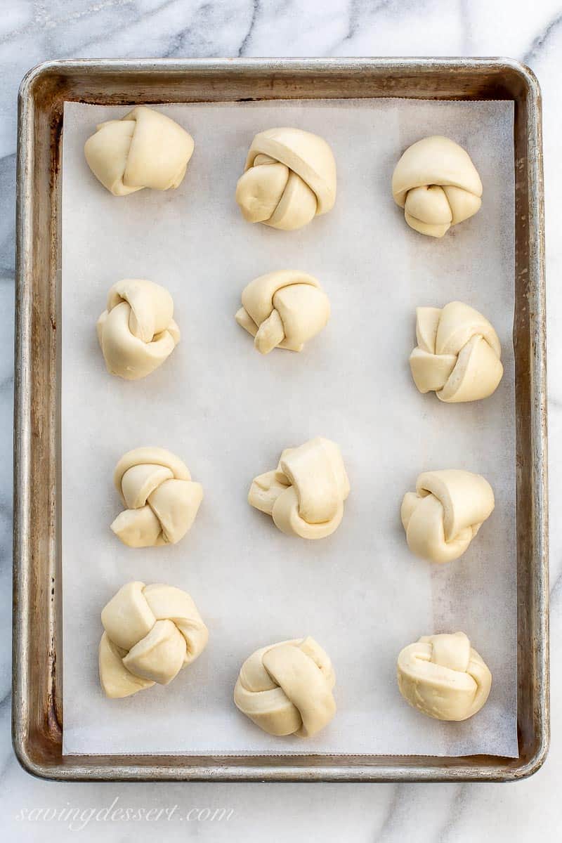 Pizza dough tied into knots on a baking pan