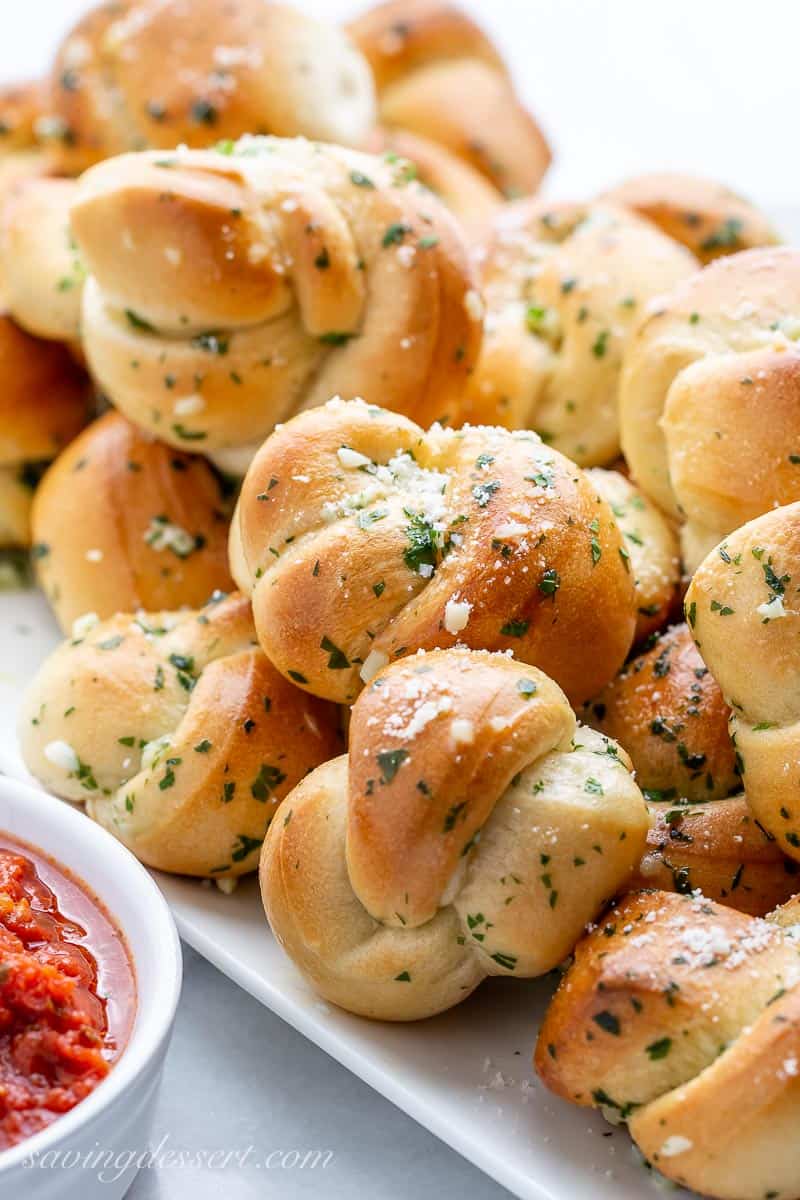 Easy buttery garlic knots with a bowl of marinara