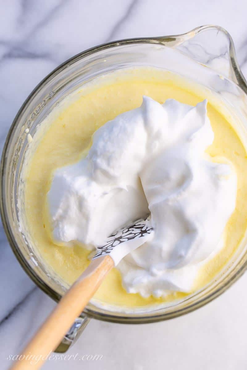 Whipped egg whites being folded into a cake batter