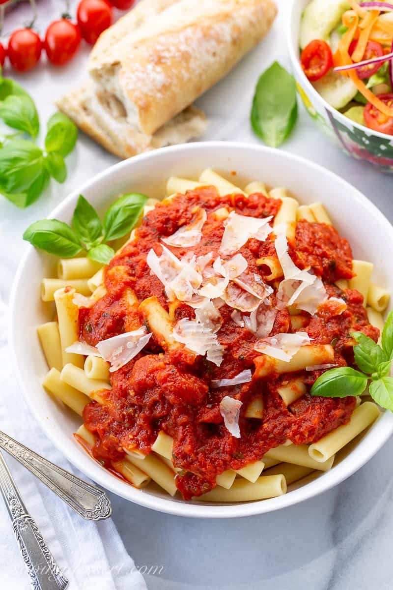 Overhead view of a bowl of pasta topped with Parmesan cheese