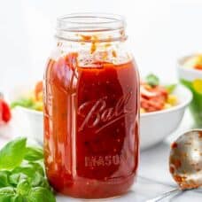 A mason jar filled with homemade marinara sauce
