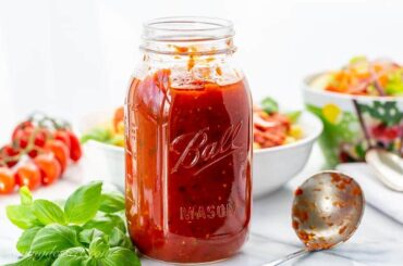 A mason jar filled with homemade marinara sauce