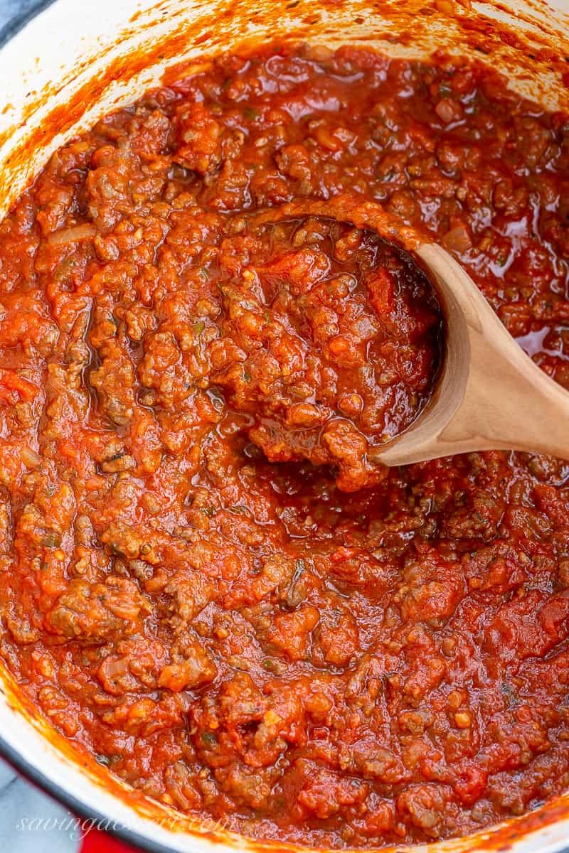 A Dutch oven filled with meaty red sauce