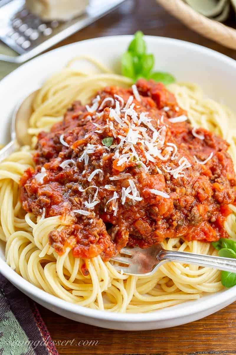 A bowl of spaghetti covered in homemade meaty spaghetti sauce