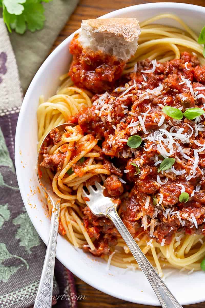 Close up of a fork full of spaghetti and a rich red tomato sauce