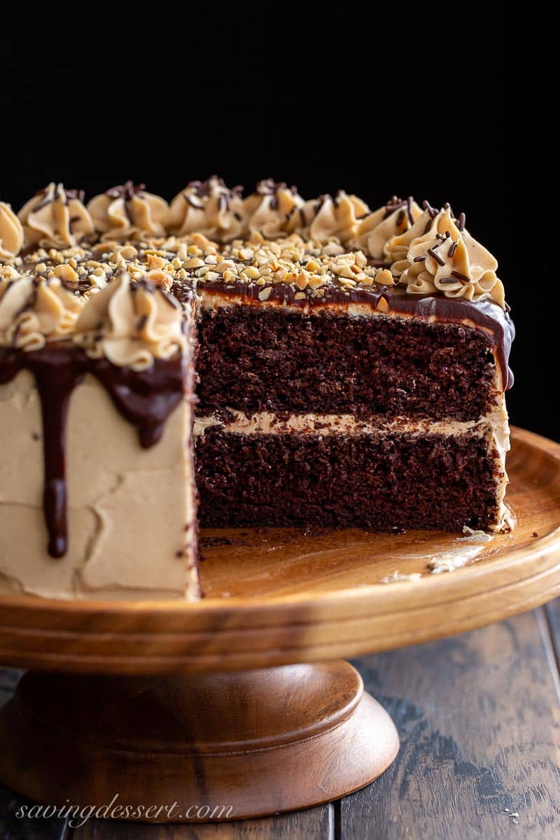 A sliced chocolate cake showing the inside with peanut butter frosting