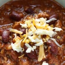 Overhead view of Bowl of chili with cheese
