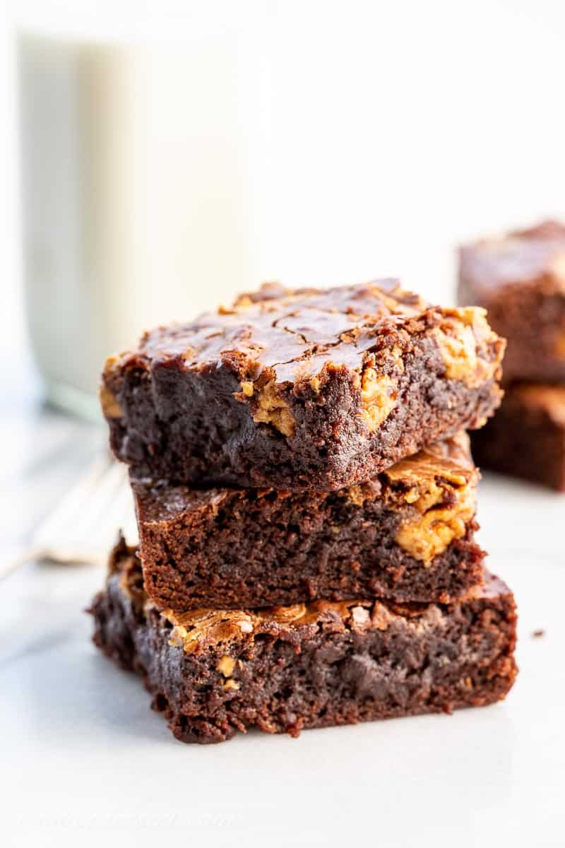 Closeup of a stack of brownies with a swirl of peanut butter