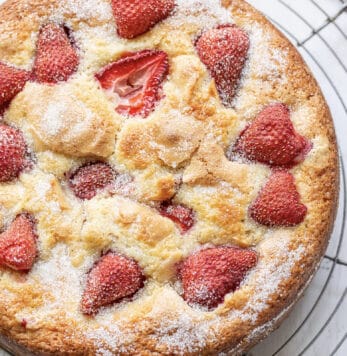 Close up shot of a strawberry cake on a cooling rack