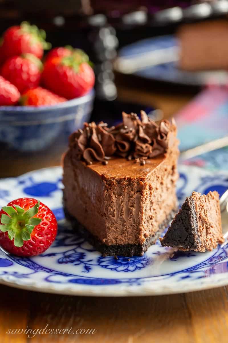 A partially eaten slice of chocolate cheesecake