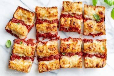 Overhead view of a sliced thick crust Detroit-Style Pizza