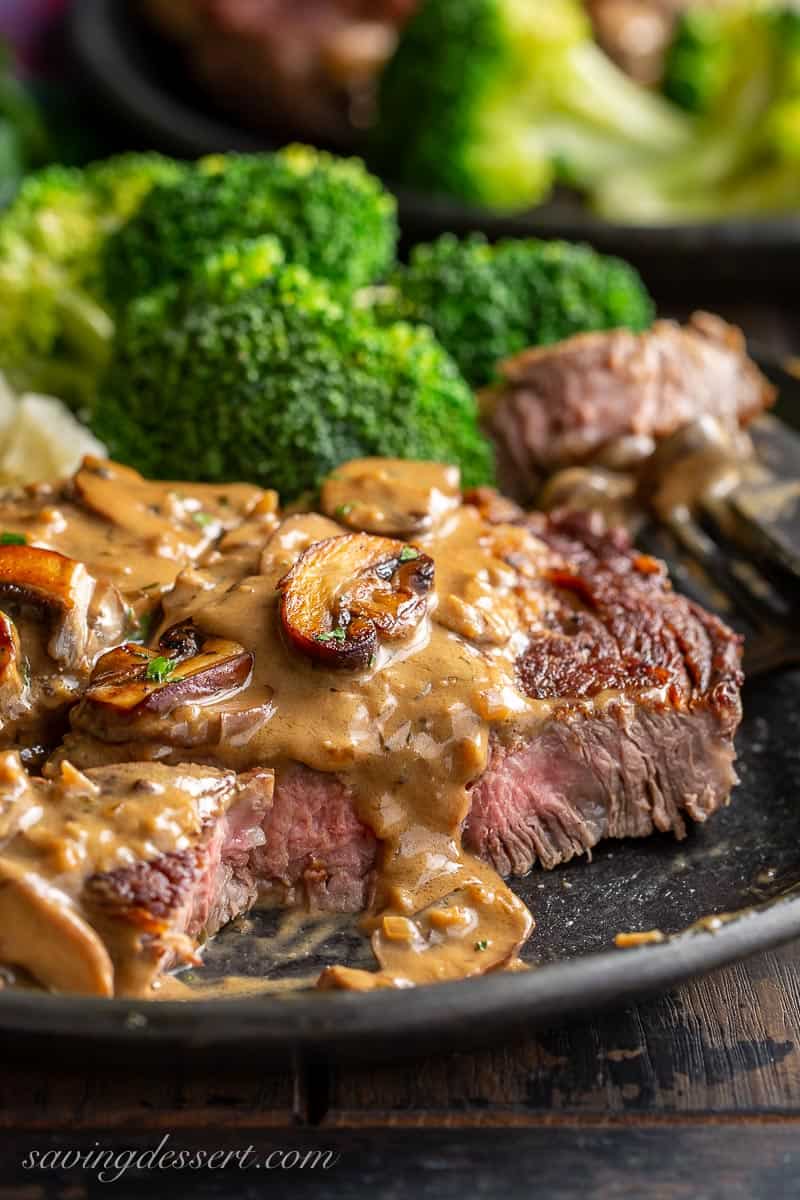 A sliced steak with mushroom sauce on top