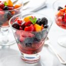 Fresh fruit salad in glasses and dessert bowls
