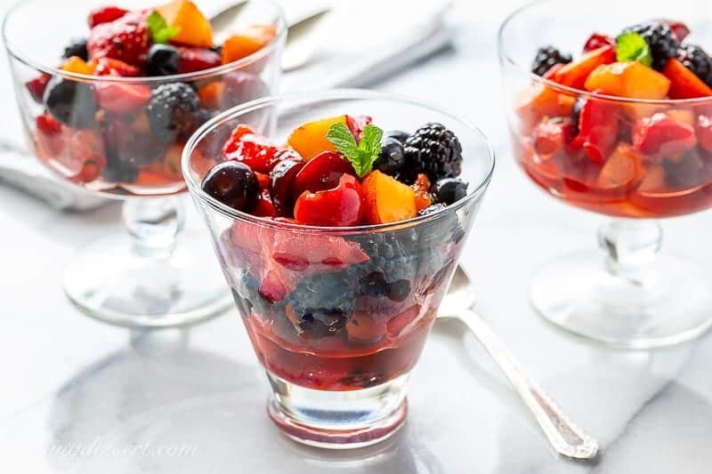 Fresh fruit salad in glasses and dessert bowls