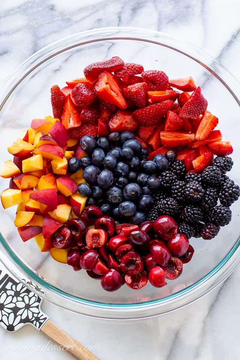 A bowl of fresh berries and peaches