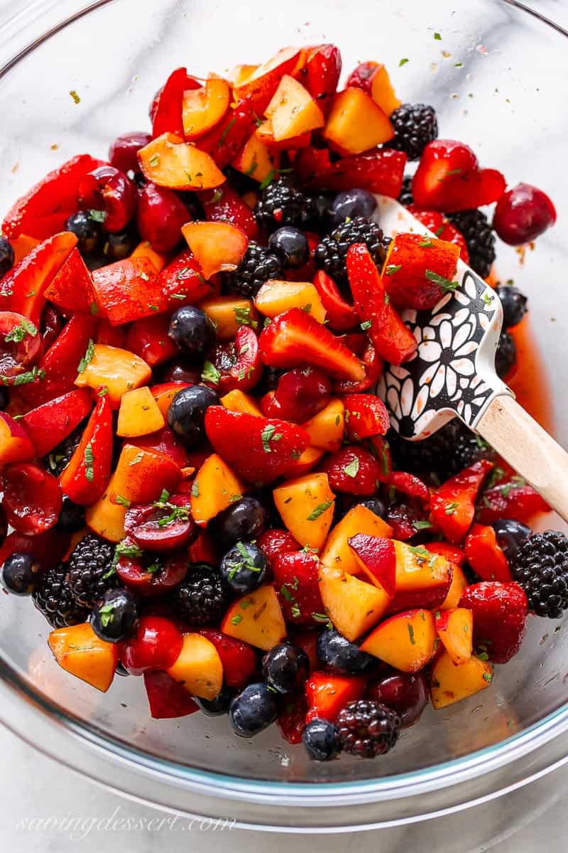A big bowl of fresh fruit and berries in tangy lime juice