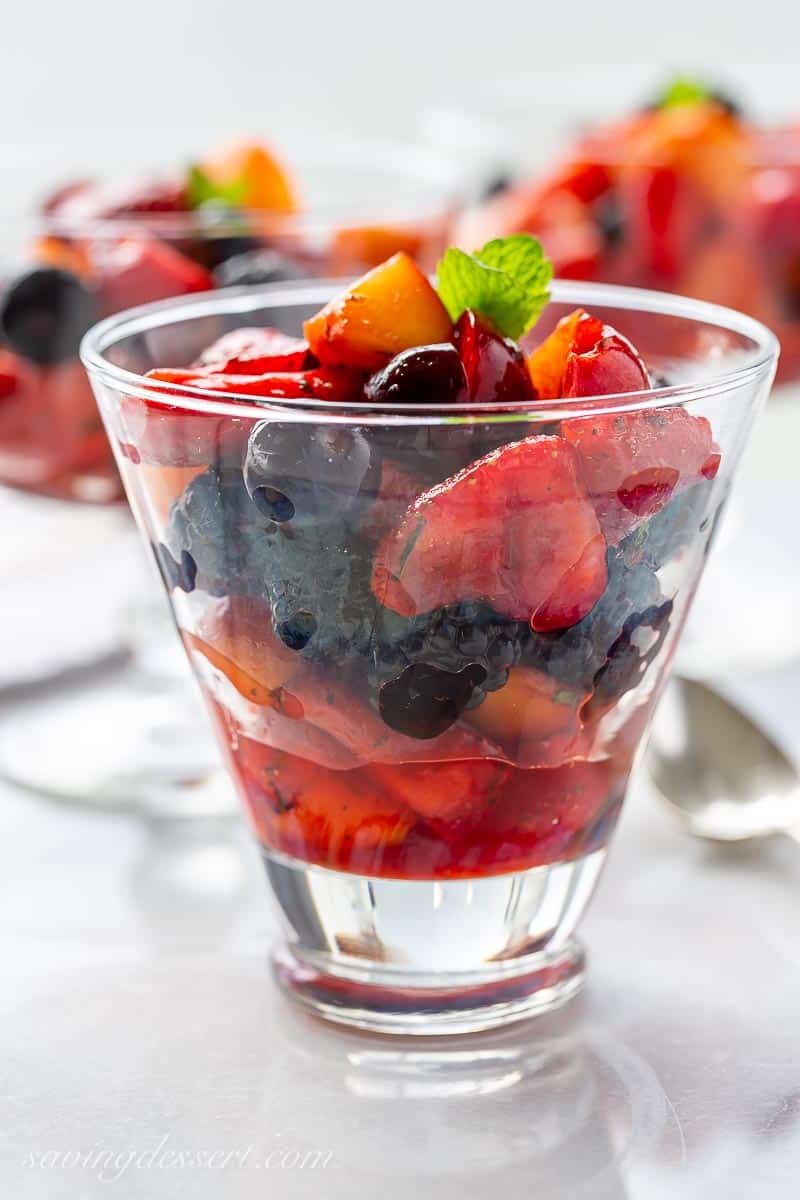Closeup of a glass of fruit fruit salad with juices and mint