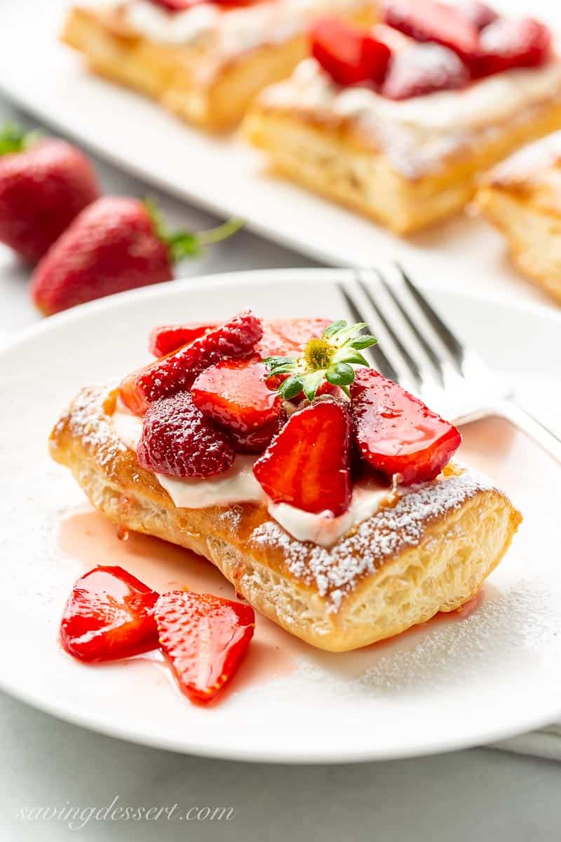 Closeup of a puff pastry strawberry tart with a fork