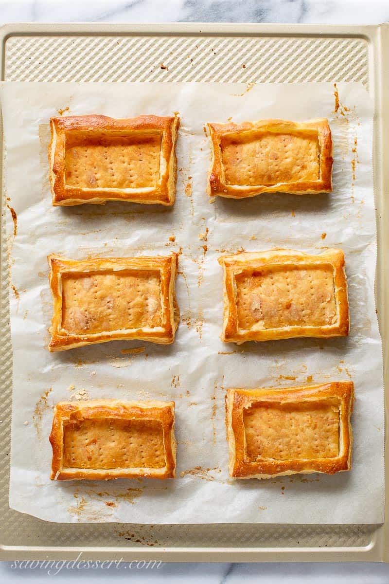 Baked puff pastry tart shells on a baking sheet