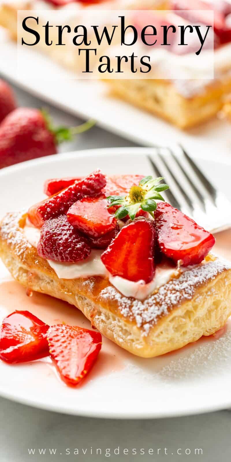 A cream filled pastry tart topped with strawberries and dusted with powdered sugar
