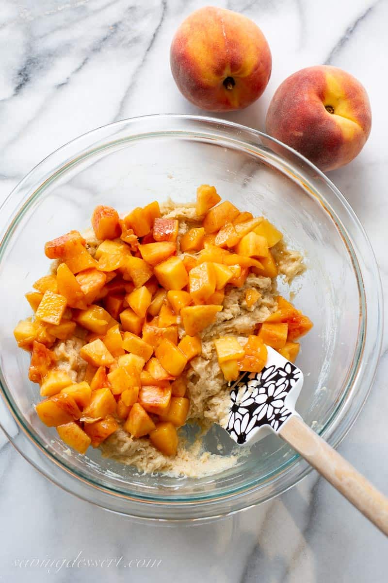 muffin batter with chopped peaches on top