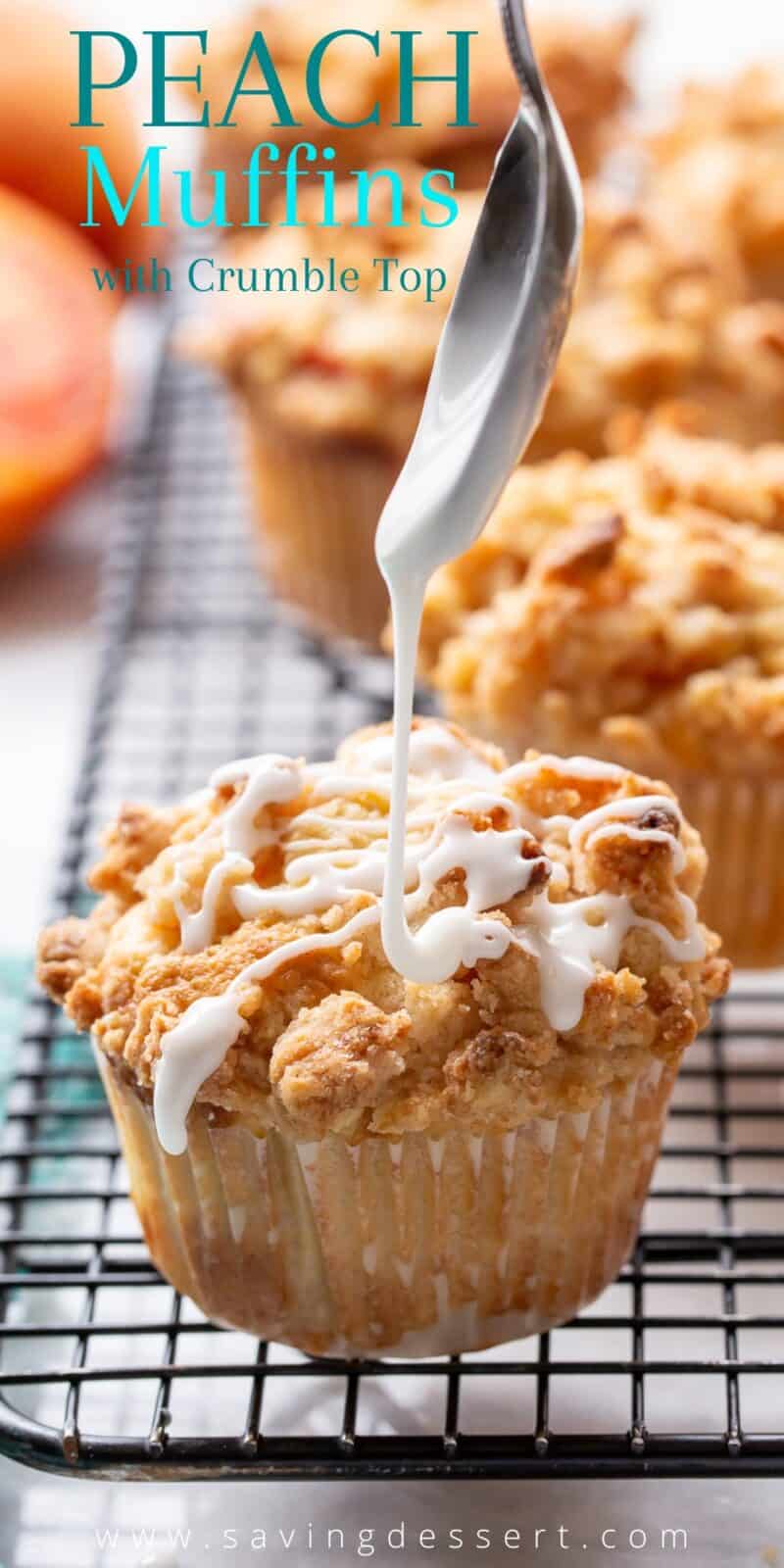 A large peach muffin being drizzled with almond icing from a spoon
