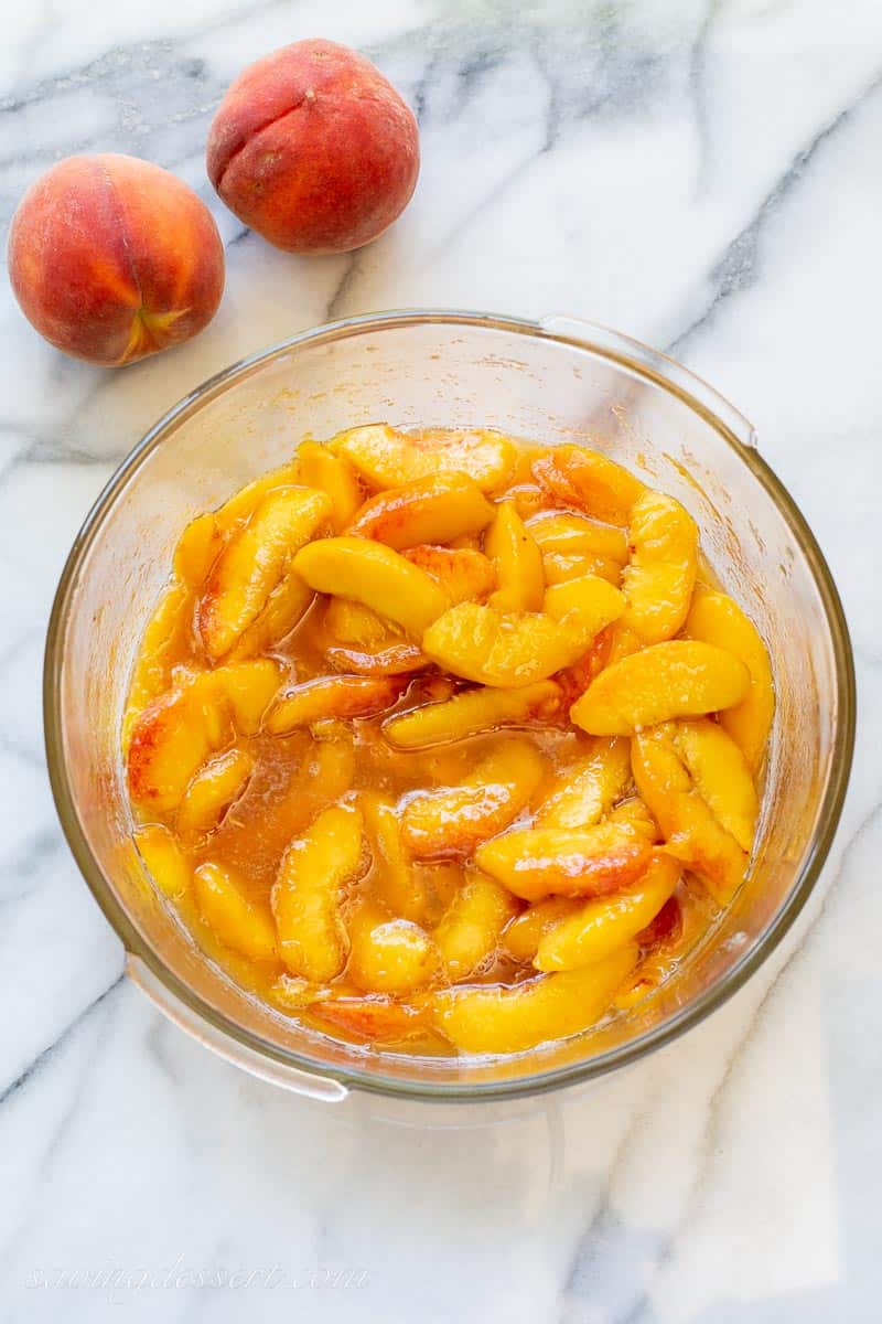 A bowl of sliced fresh peaches in sugar