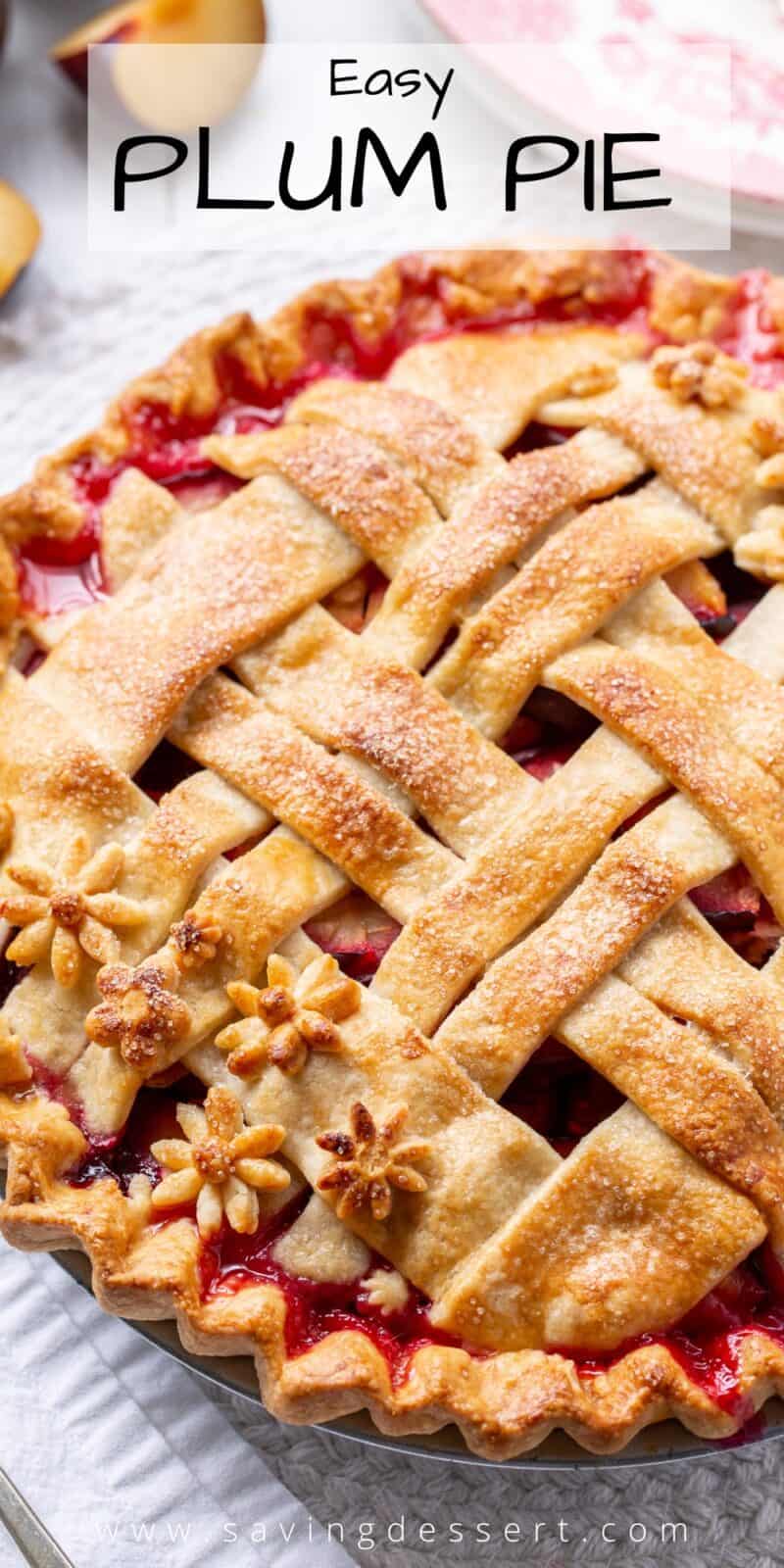 Overhead view of a lattice crust topped plum pie with flower cutouts