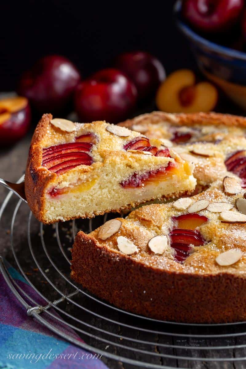 A slice of rustic plum cake on a serving spatula