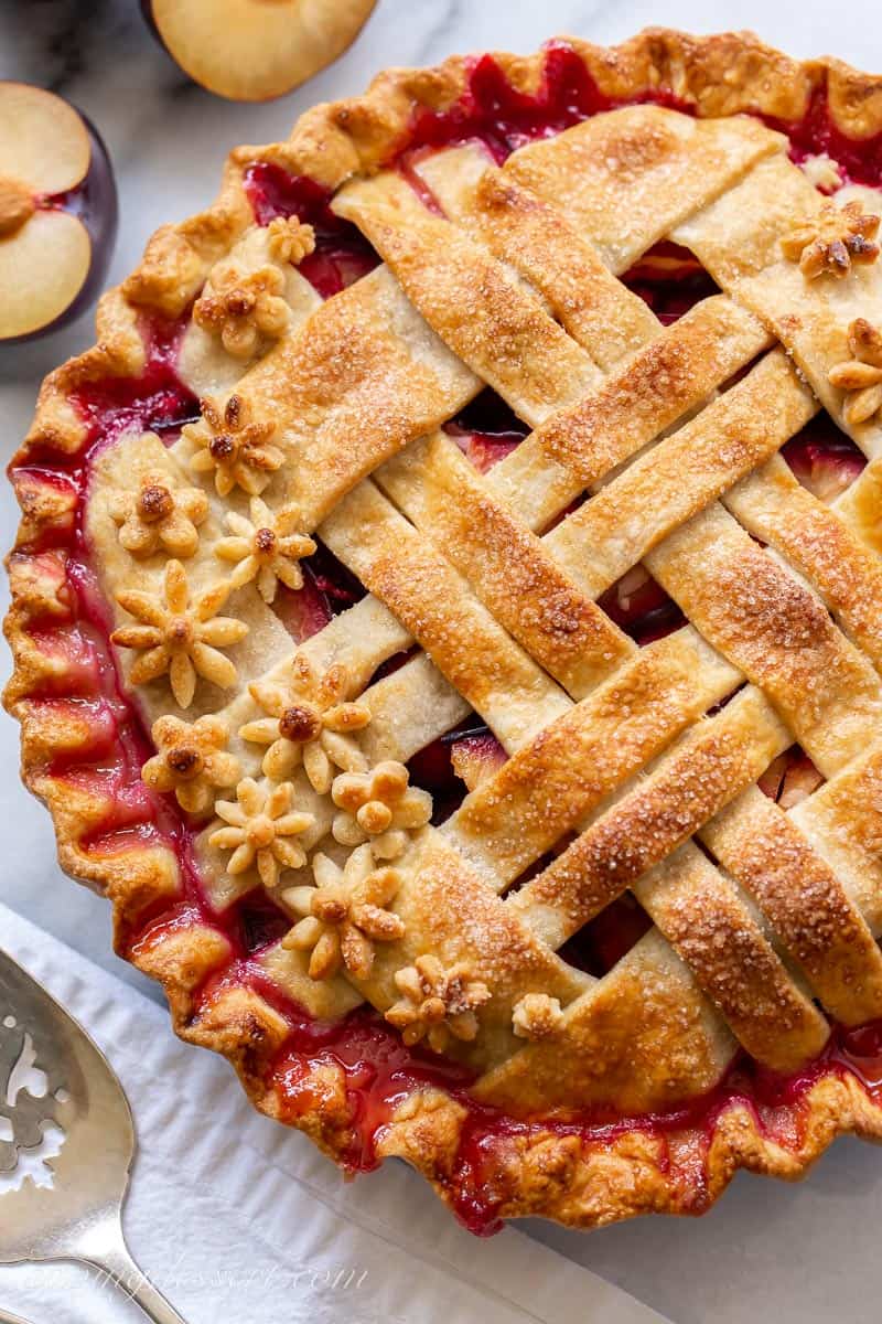 Overhead view of a baked lattice topped plum pie