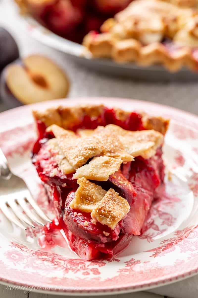 A slice of plum pie on a plate