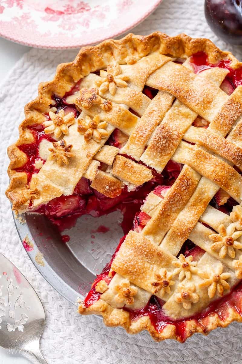 Overhead view of a sliced plum pie