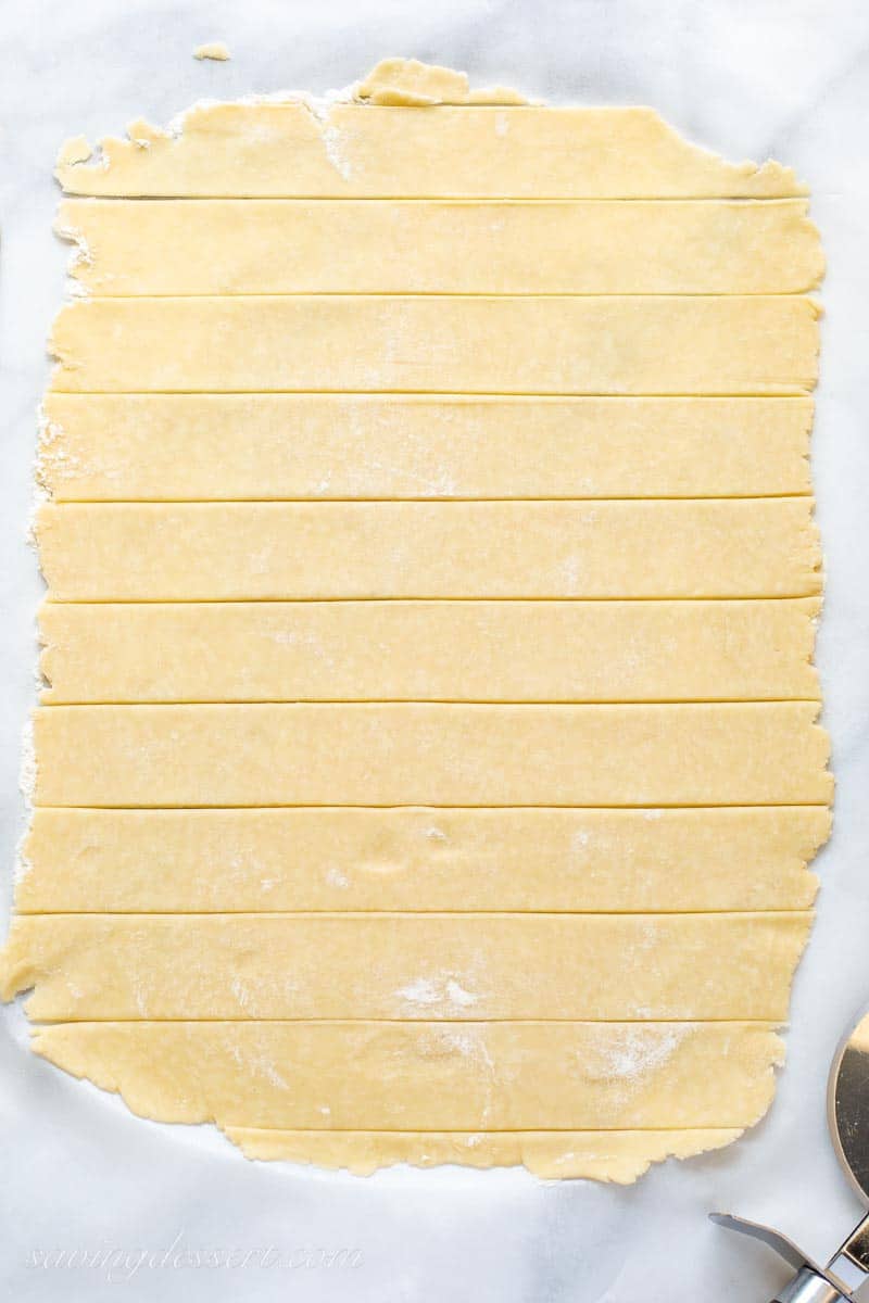 A rolled out pastry crust cut into strips