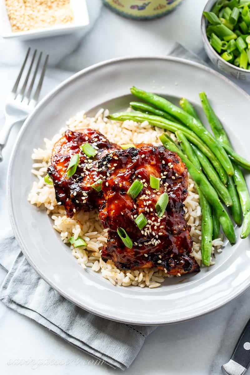 Overhead view of a plate with chicken, rice and green beans