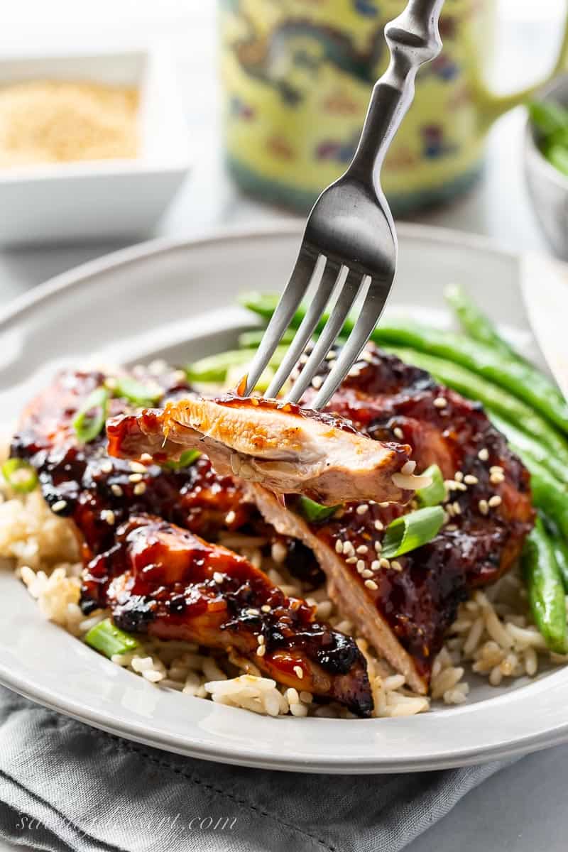 A sliced piece of chicken on a fork