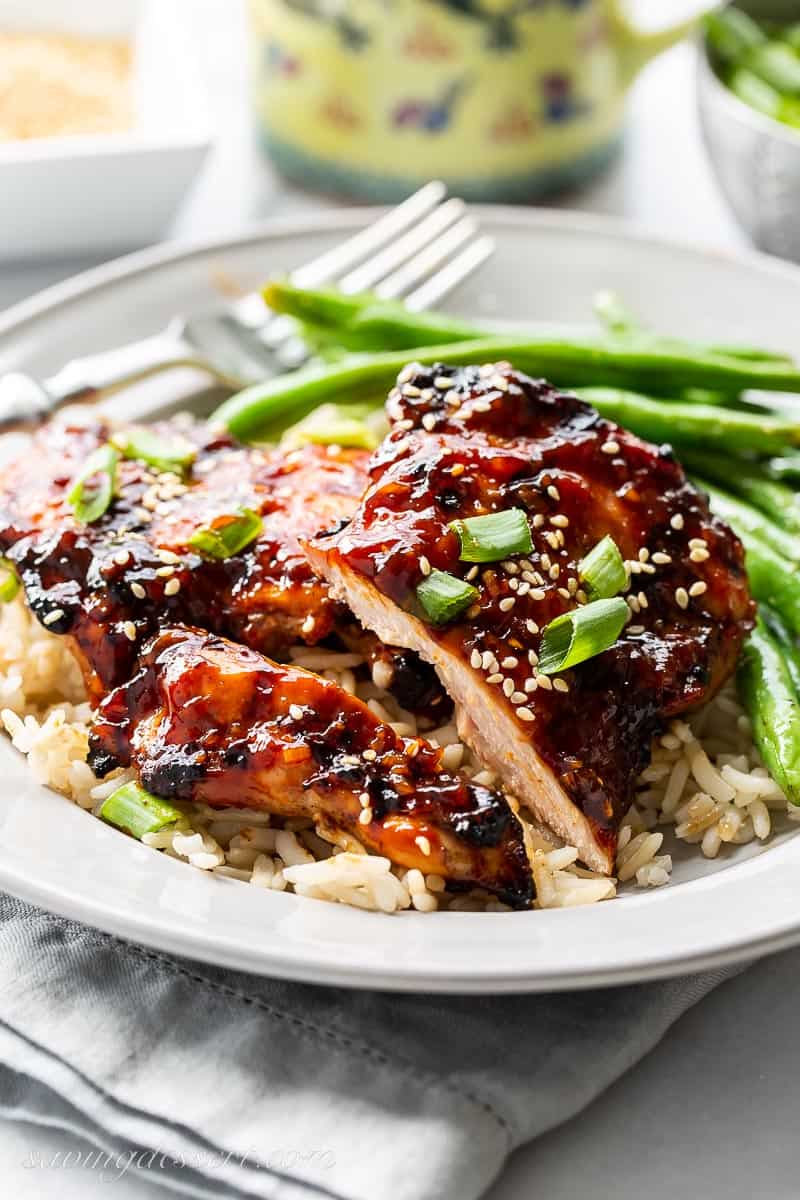 Asian Chicken on a plate over brown rice with green beans