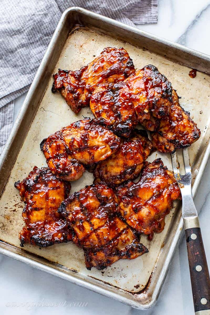 Grilled chicken thighs on a baking pan