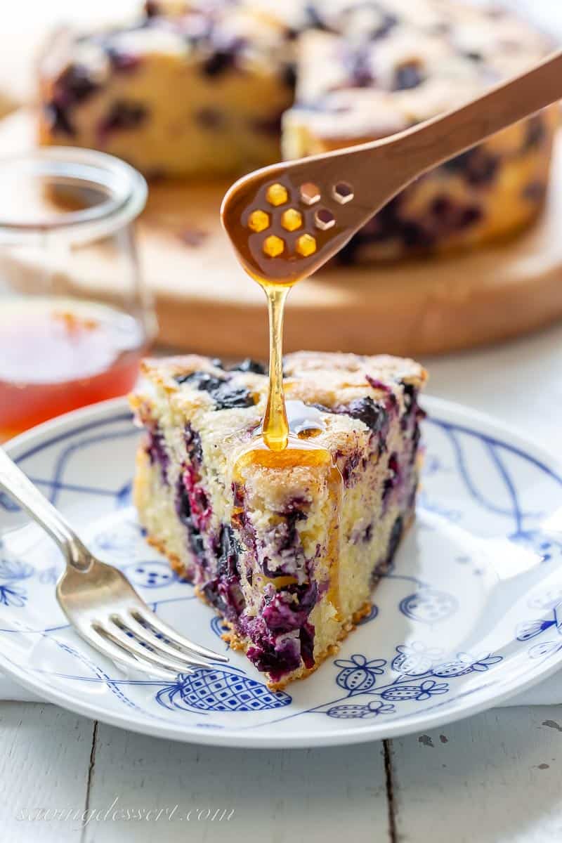 A slice of cornbread being drizzled with honey