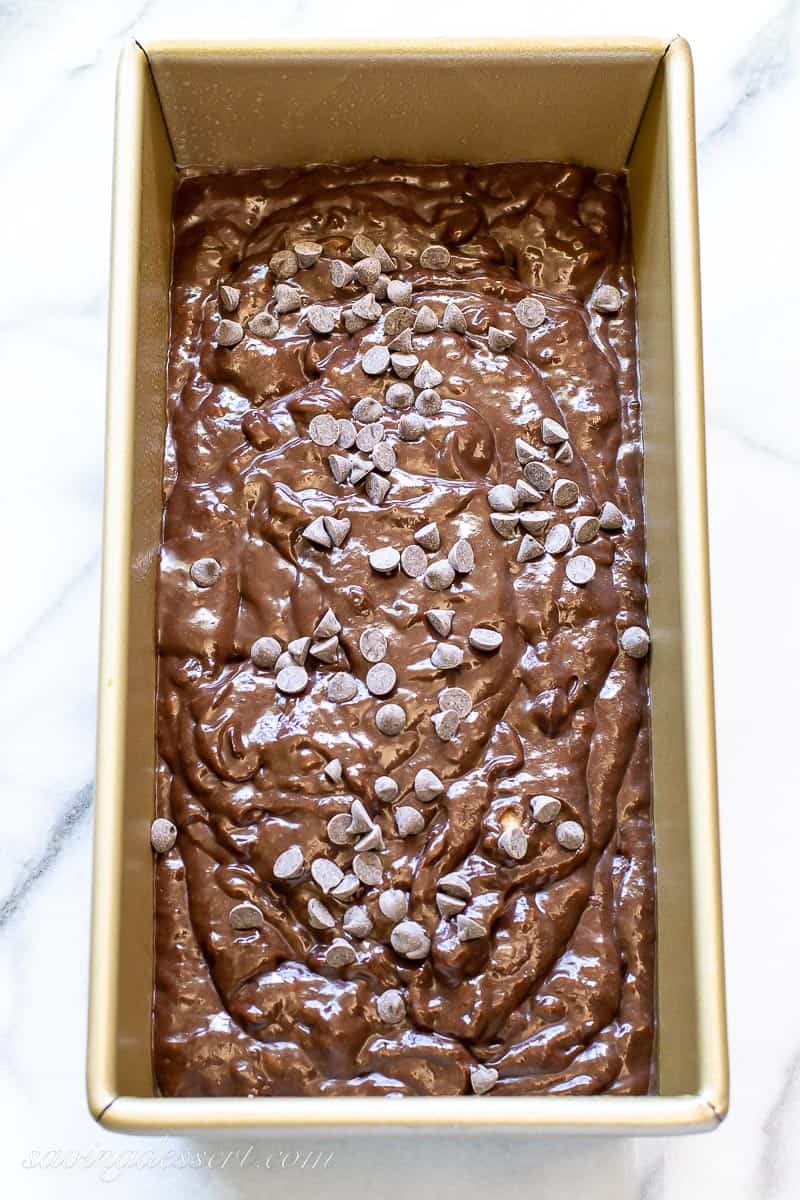 Chocolate batter in a loaf pan sprinkled with mini chocolate chips
