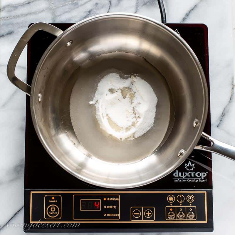 Overheat shot of a saucepan with sugar and water on a stovetop