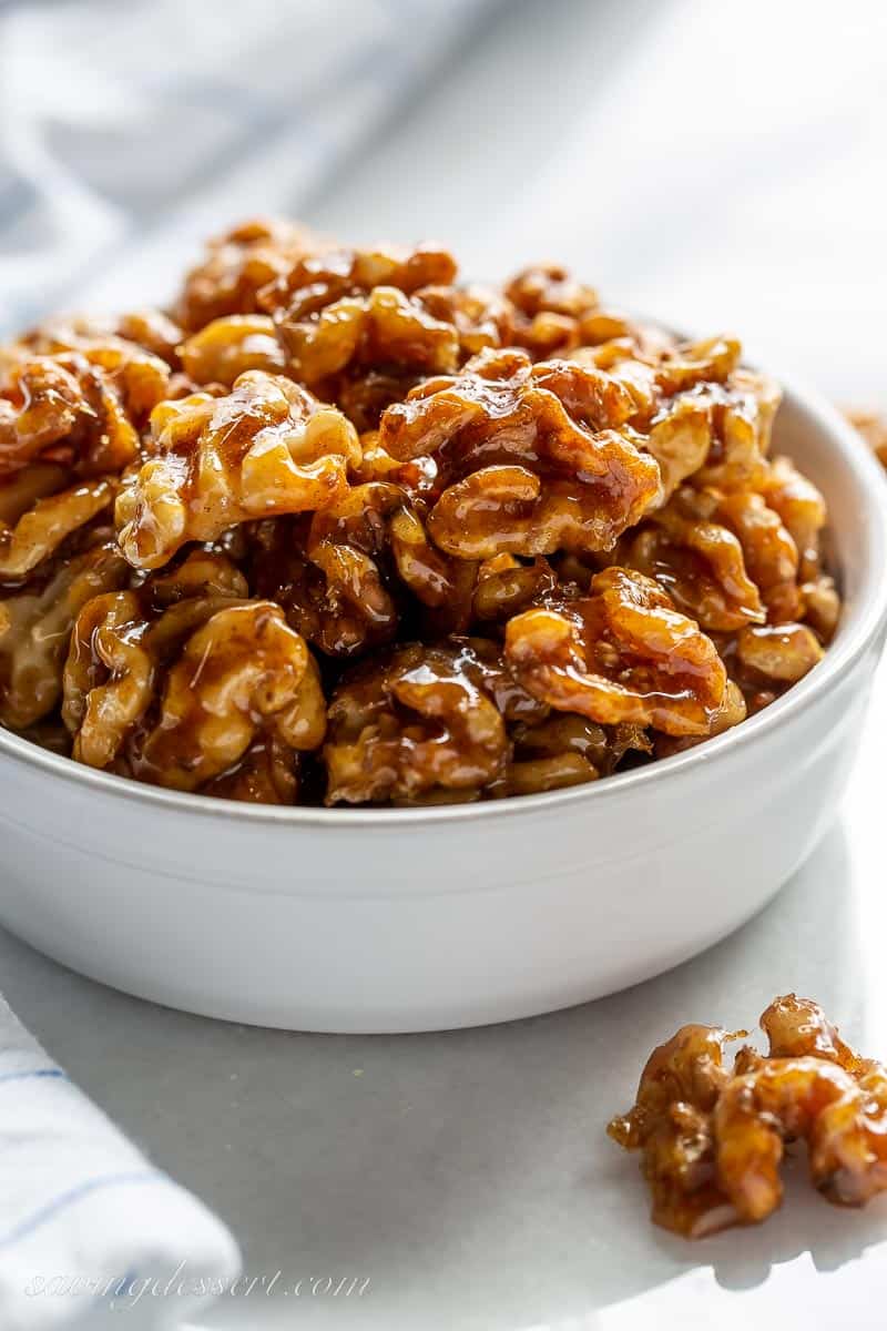 A side view of a bowl of candied walnuts