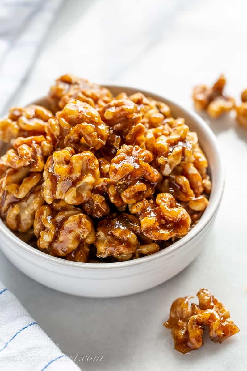 A side view of a bowl of candied walnuts