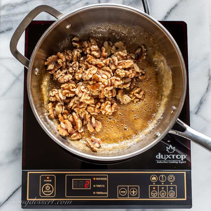 A saucepan with caramelized sugar and walnuts