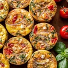 Egg muffins with tomato, feta and onion on a baking sheet