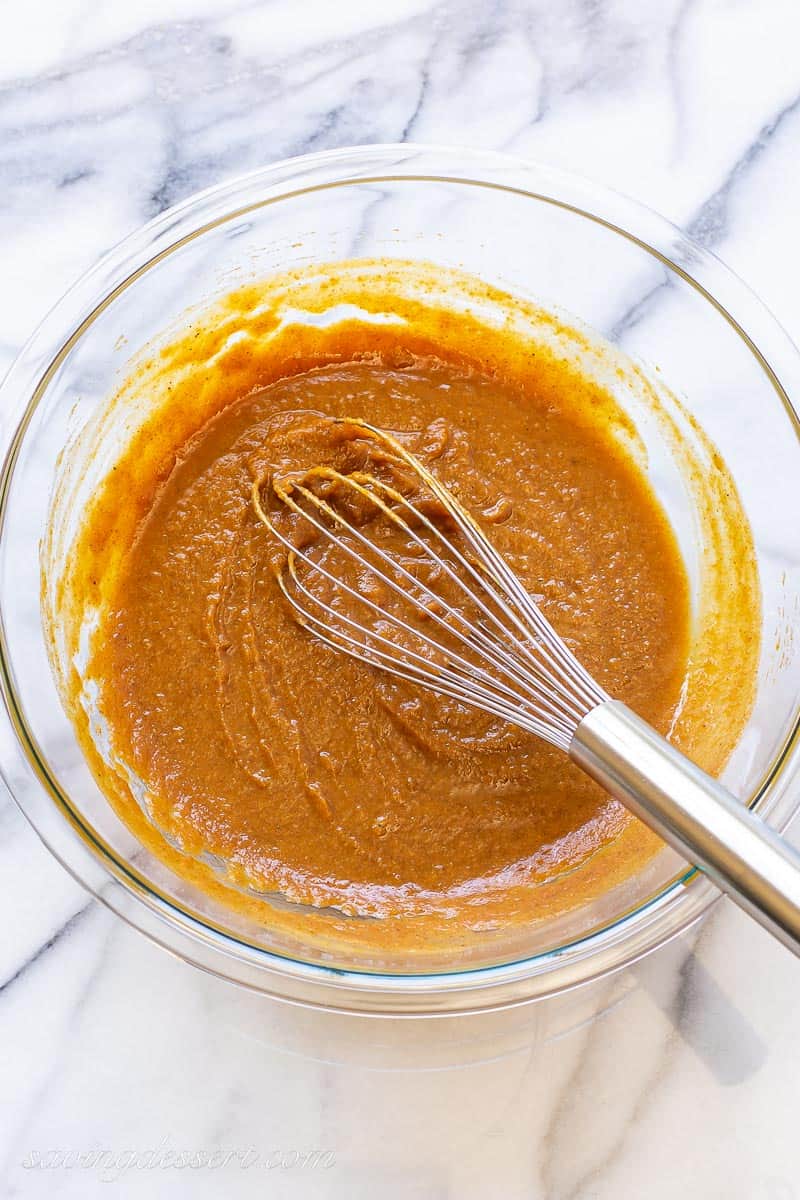 a bowl of pumpkin puree whisked with spices and sugar